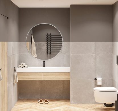 Modern bathroom with gray walls and wooden floors, a round mirror above the washbasin with a wooden cabinet, a toilet, a bathrobe near the door, spotlights on the ceiling. Front view. 3d render